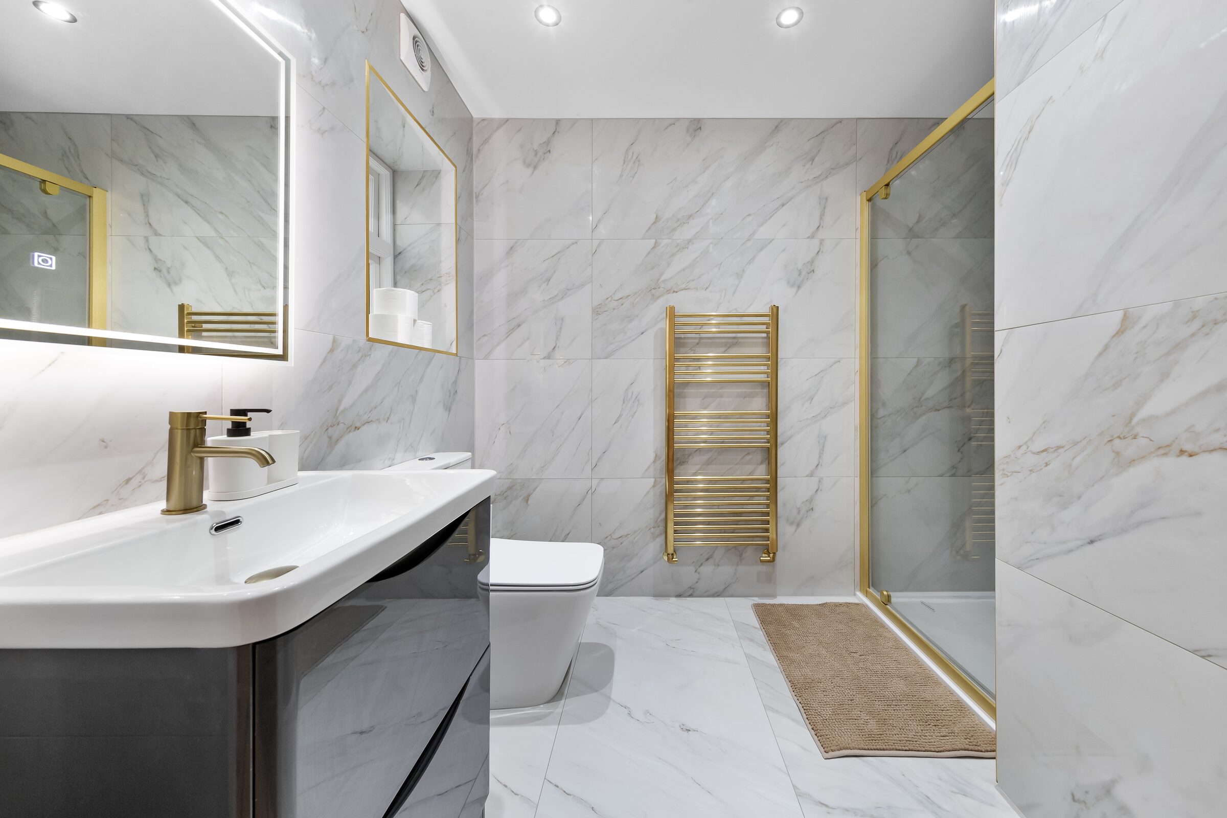 Marble bathroom — vanity, WC and rain shower