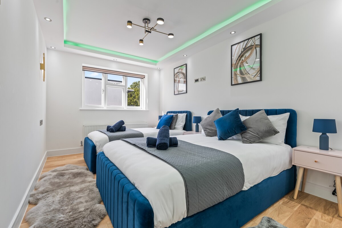 Bedroom 2 — double and single beds with velvet headboards