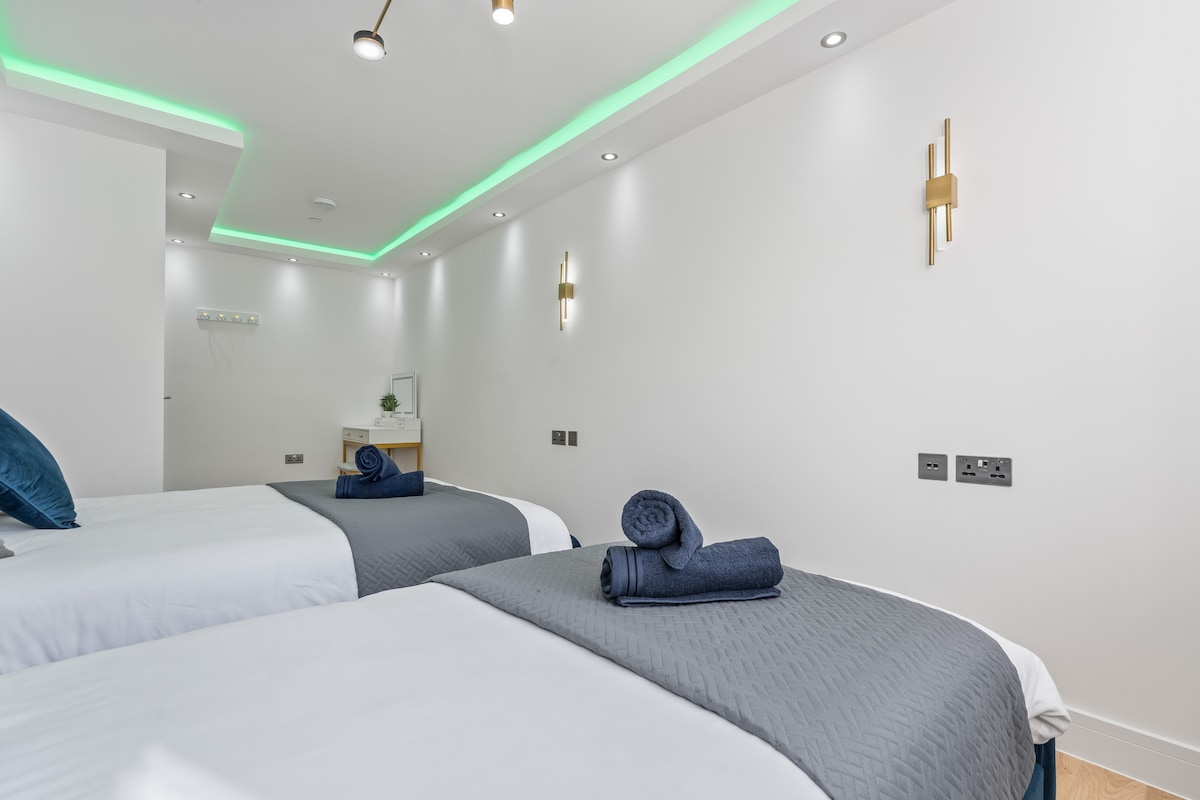 Bedroom 2 — double and single beds with LED lighting