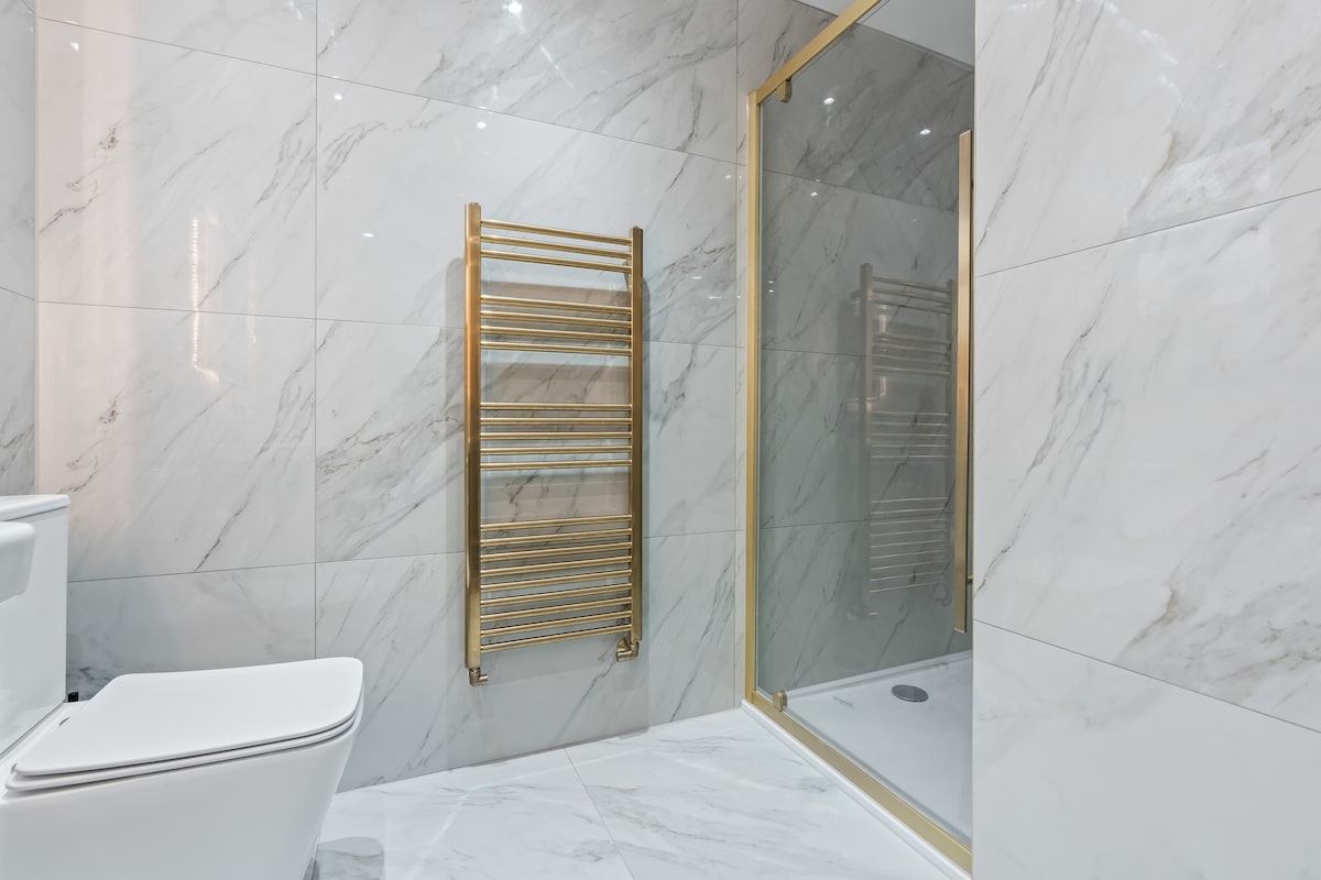 Marble walk-in shower with heated towel rail
