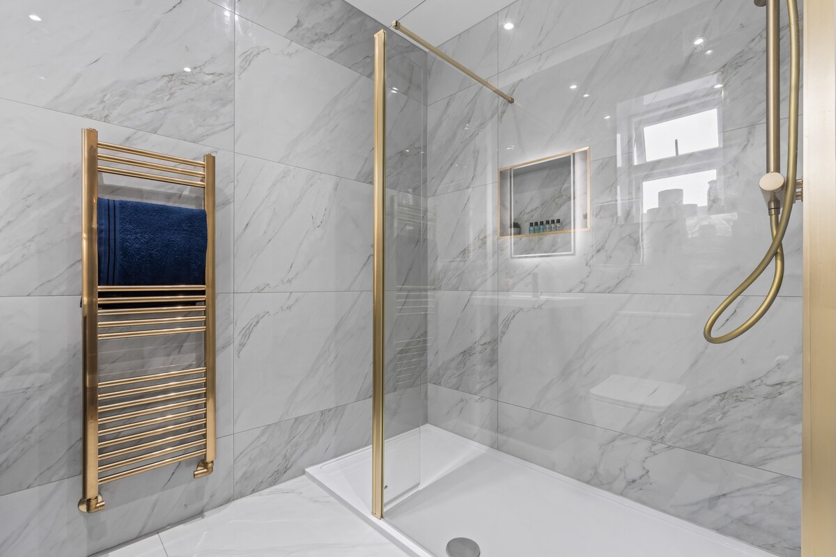 Marble walk-in shower with heated towel rail